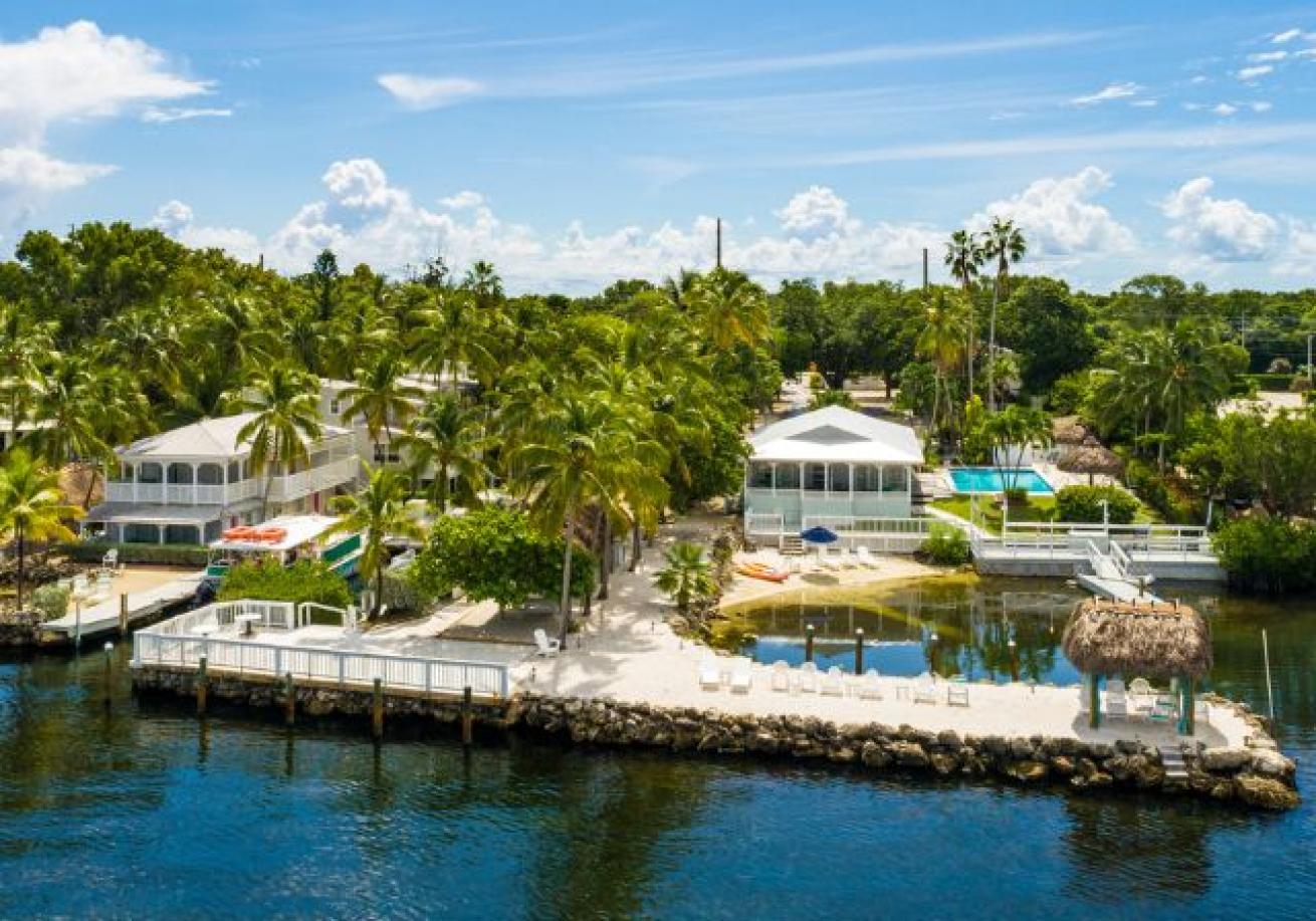 A group of houses on a dock next to a body of water